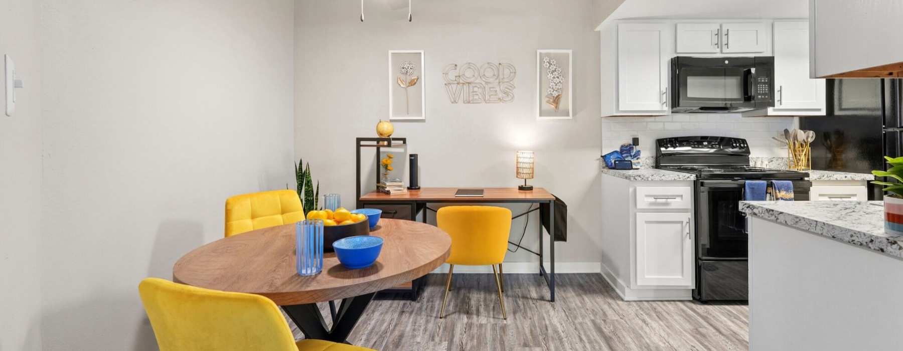 dining and work spaces open to well lit kitchen