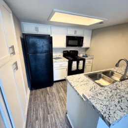 a kitchen with white cabinets