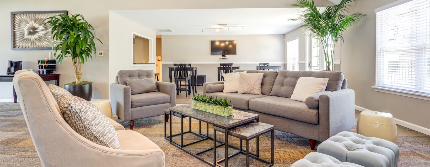 a clubroom with a couch, table and chairs