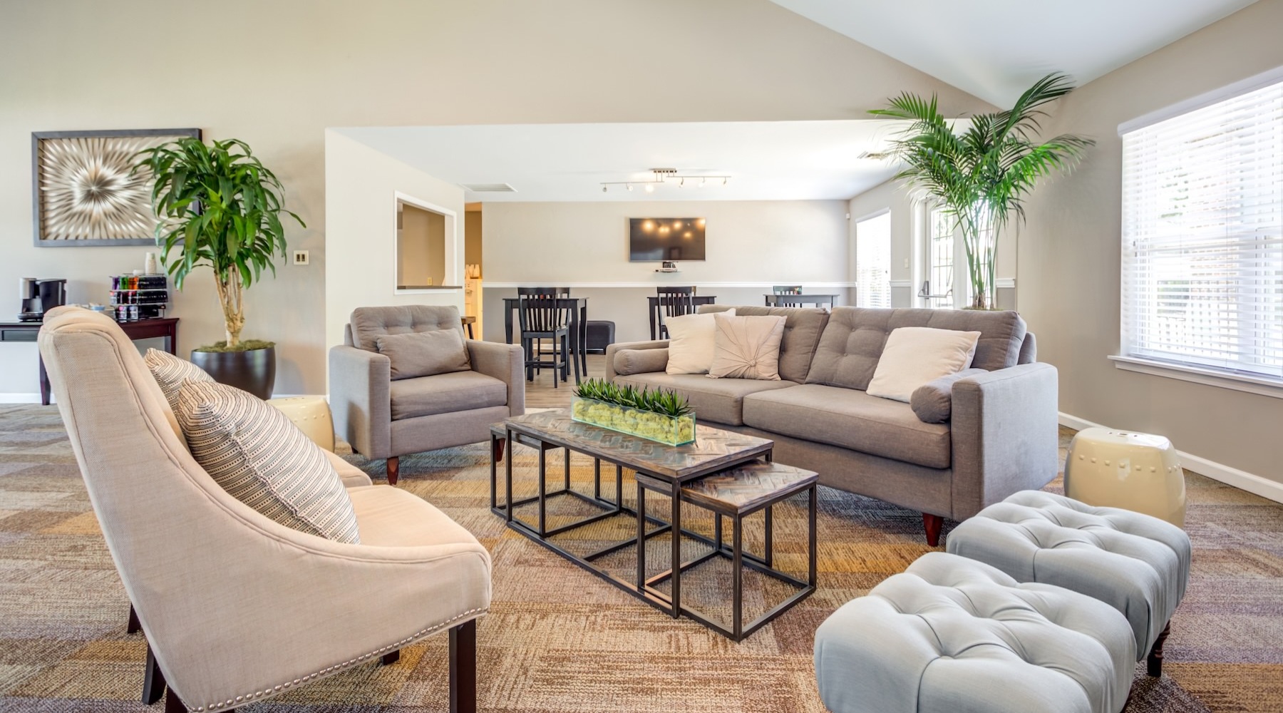 a clubroom with a couch, table and chairs