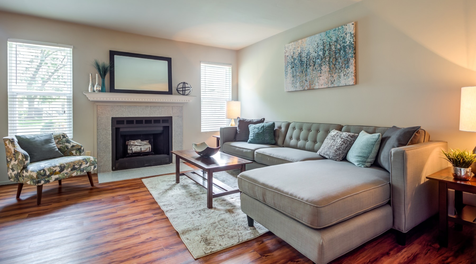 a living room with a couch, table and a fireplace
