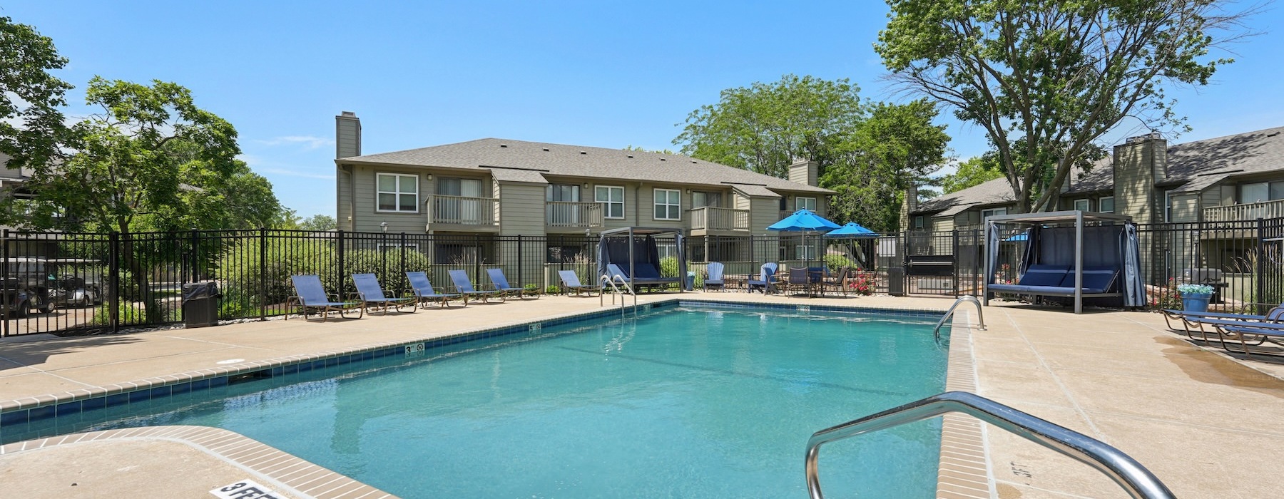 lounge chairs surround large pool