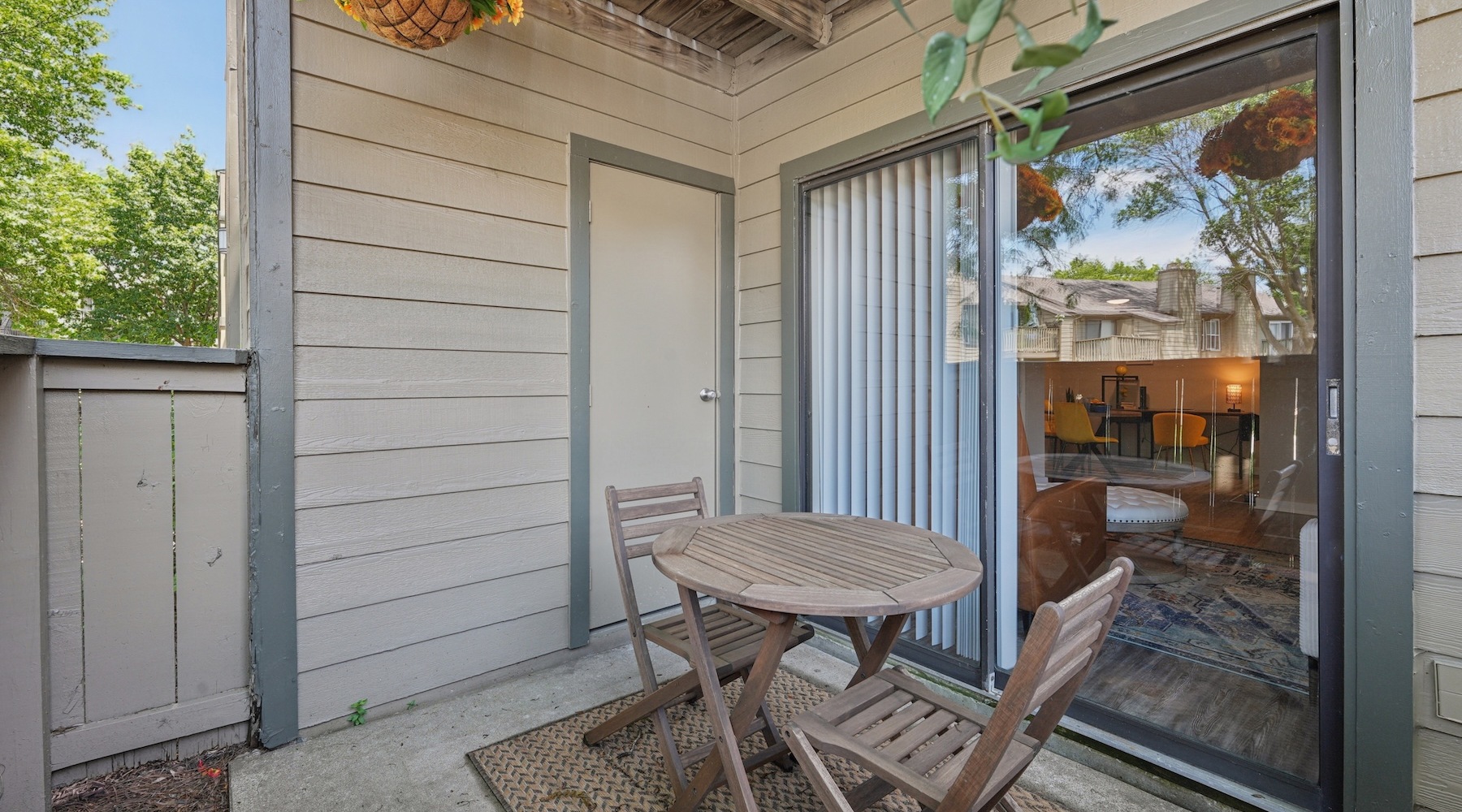 a patio with a table and chairs